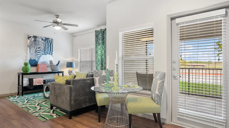 the living room has a sliding glass door and a table at The  BLVD